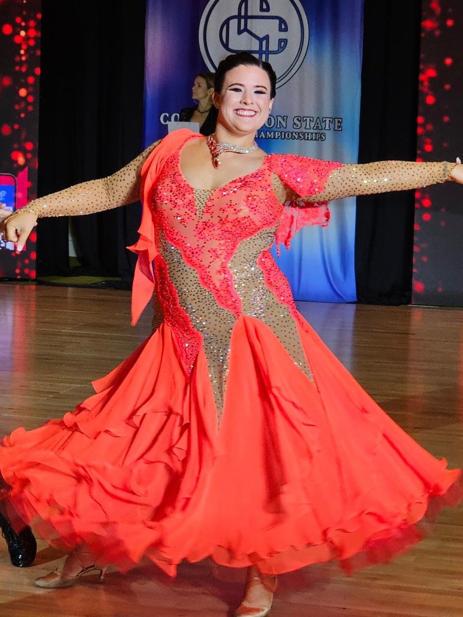 Joyful dancing lady in bright dress