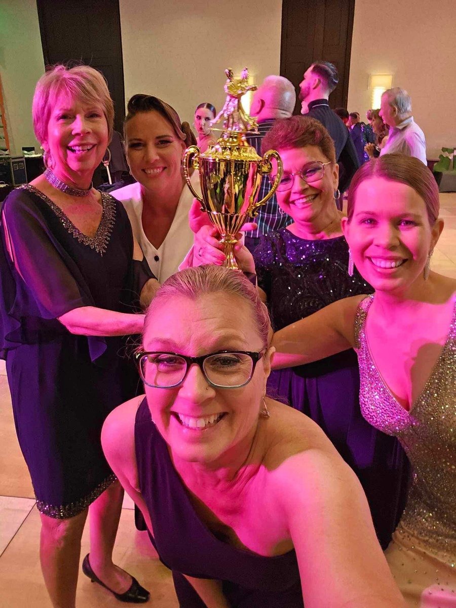 ladies holding a trophy