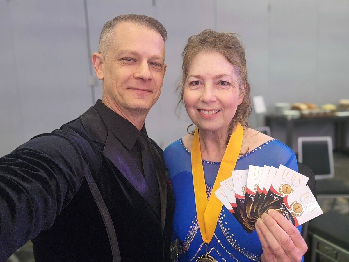 2 performers holding tickets